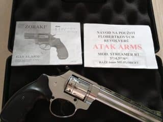 2A Marketplace: Private Firearm Classifieds A silver revolver rests in a black foam case, accompanied by instruction manuals and papers. The case sits open on a wooden surface. Private sale of guns.