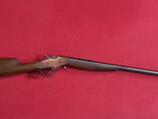 2A Marketplace: Private Firearm Classifieds A single-shot, lever-action rifle with a wooden stock and a long metal barrel, displayed on a solid red background. Private sale of guns. 2A Marketplace: Private Firearm Classifieds A single-shot, lever-action rifle with a wooden stock and a long metal barrel, displayed on a solid red background. Private sale of guns.